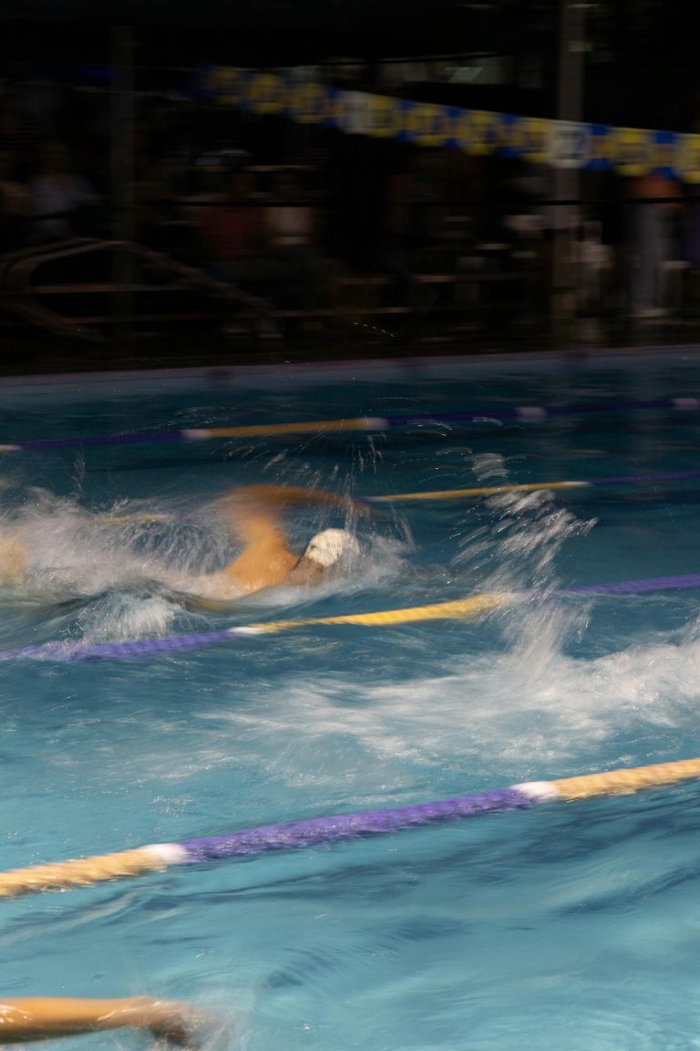 Dynamic shot of swimmers competing in a pool race in San Luis Potosí.